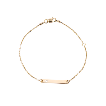 Gold bracelet with a bar charm on a white background